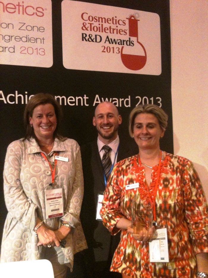 Dow Corning Corp. representatives proudly holding their 2013 Cosmetics & Toiletries R&D Award for Best New Ingredient with Jeff Falk, Editor in Chief of Cosmetics & Toiletries and GCI magazines.