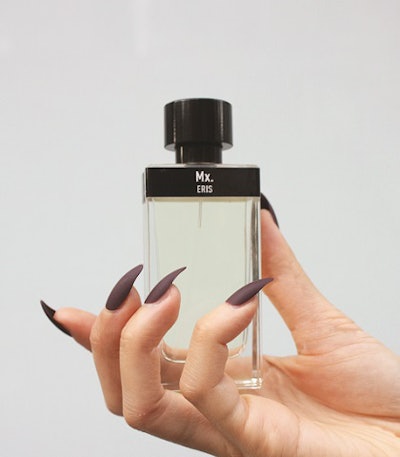 Someone holding a bottle of Mx. perfume