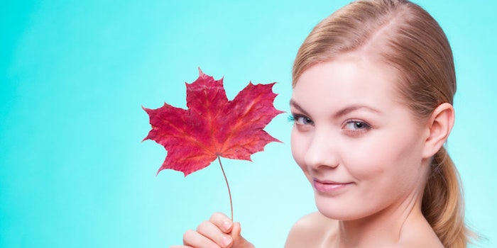 WomanHoldingRedMapleLeaf850x425