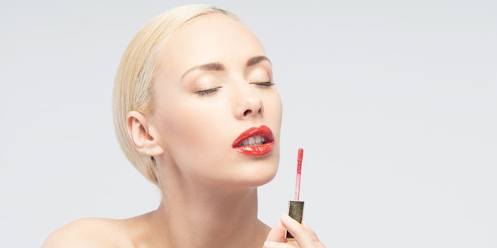PhoenixWomanApplyingRedLipGloss850x425