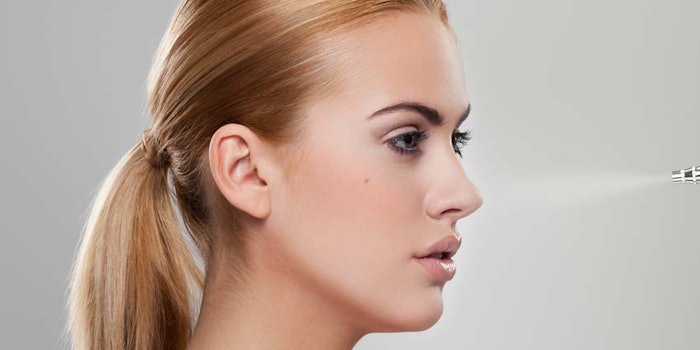 WomanSprayingMakeup850x425