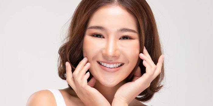 YoungAsianWomanPattingHerCheeks850x425