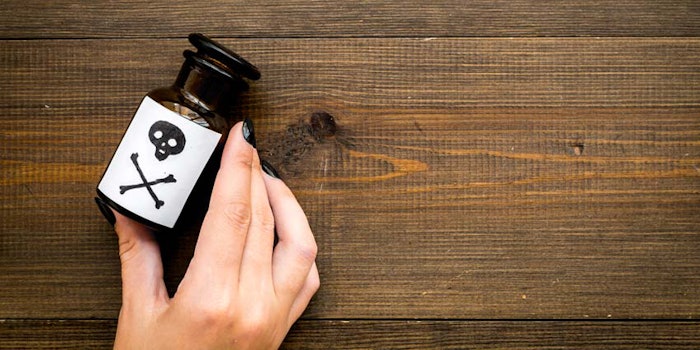 PoisonBottleonWoodHand850x425