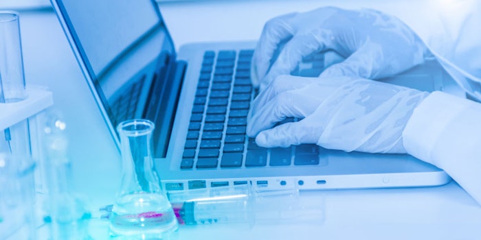 scientisttypingcomputerlabglassware850x425