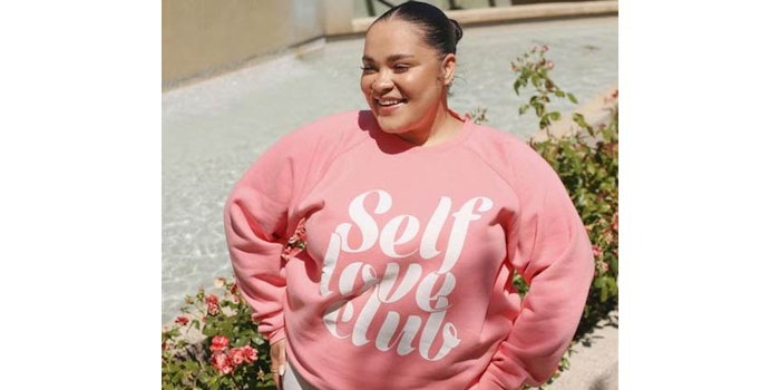 The Self Love Club Big Sister Crew Neck Sweatshirt is a limited-edition collaboration featuring Brunette The Label's cursive graphic on Benefit's 1976 pink fabric.