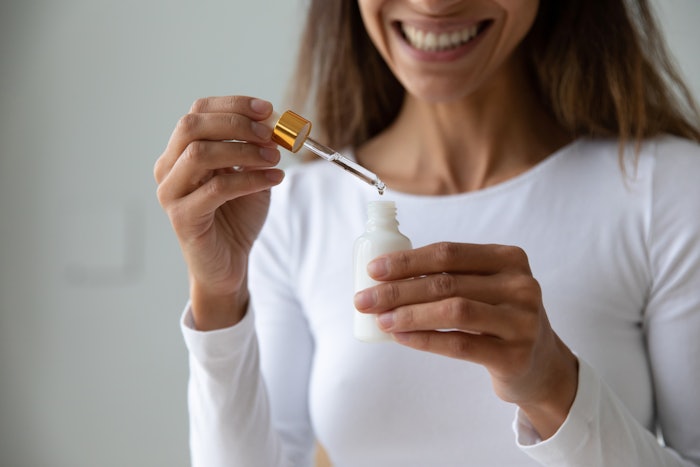 Woman using collagen serum