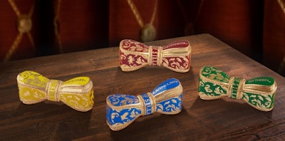 The line includes one candle, a perfume discovery coffret, and four fragrances with matching iconic bow case lipsticks celebrating the four Hogwarts houses.