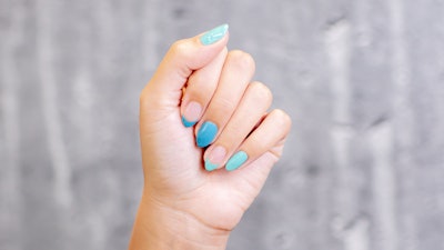 A blue manicure with French tip detail.