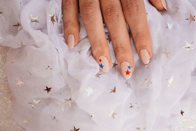 Nude polish with red and blue star nail art