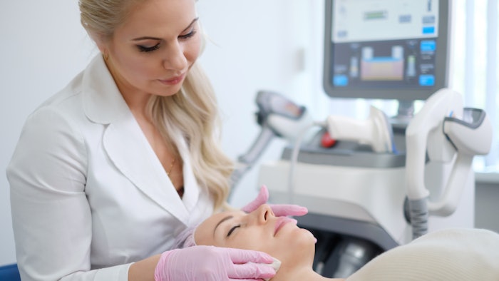Woman getting treatment with aesthetic dermatology device