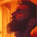 Bearded man relaxing on wooden bench in infrared sauna. Spa treatment