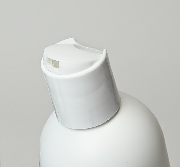 The disc-top closure features an integrated, concealed mechanism that requires more force to be applied upon initial opening, but thereafter operates as a standard disc top closure, per Aptar.