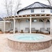 Exterior of The Spa at Nicewonder Farms and Vineyards, white yurt with lounge chairs and hot tub in foreground