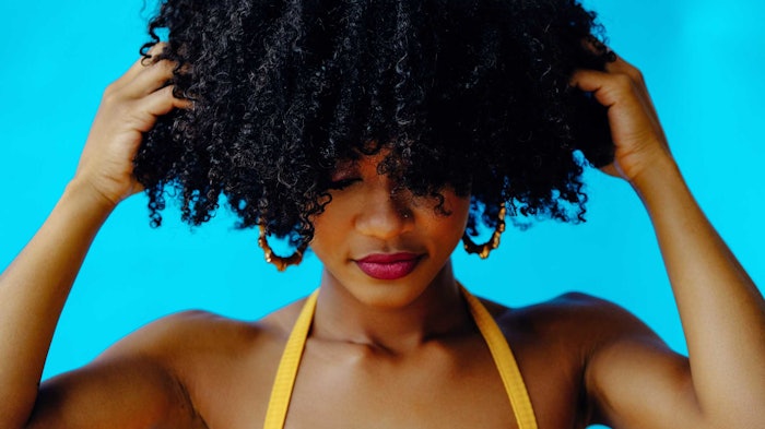 Woman Curly Hair Hands On Scalp Dsm Firmenich Scalp Formula Focus Adobe Stock 481351761