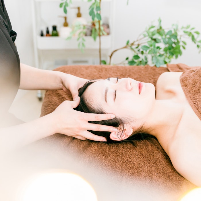 Woman getting a scalp massage.