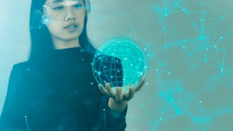 scientist holding digital depiction of globe with network connected