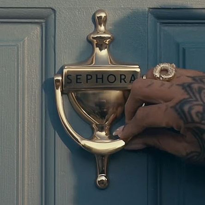 Hand on door knocker labeled Sephora.