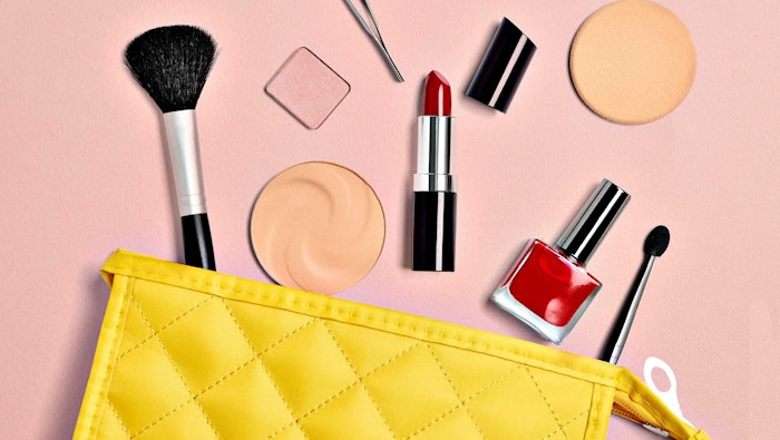 cosmetic products spilling out of yellow makeup bag