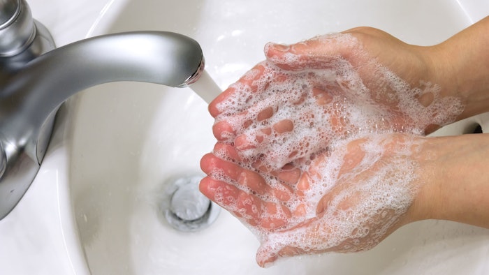 hands soapy sink water top down view bubbles
