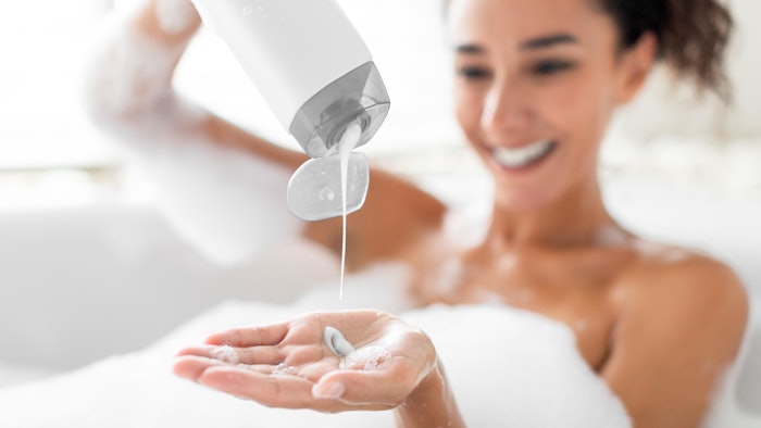 2woman in bath using body wash bubbles