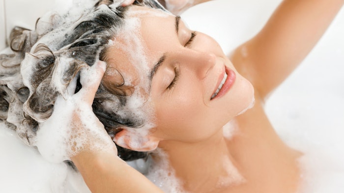 woman in shower washing hair foam and suds
