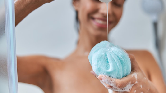 Woman In Shower Pouring Gel On Loofah Adobe Stock 382972380