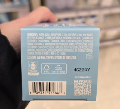 Blue skincare product packaging with ingredient list and QR code