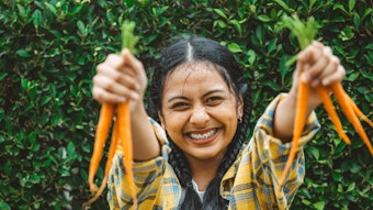 Young Woman Excited Holding Up Carrots Adobe Stock 504354316
