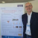 Scientific researcher presenting poster on skin tone management at cosmetic science conference