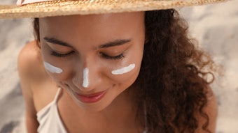 Woman In A Hat At Beach Sunscreen On Face Adobe Stock 458234417
