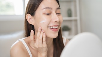 Beautiful Asian Woman Using Skin Care Products