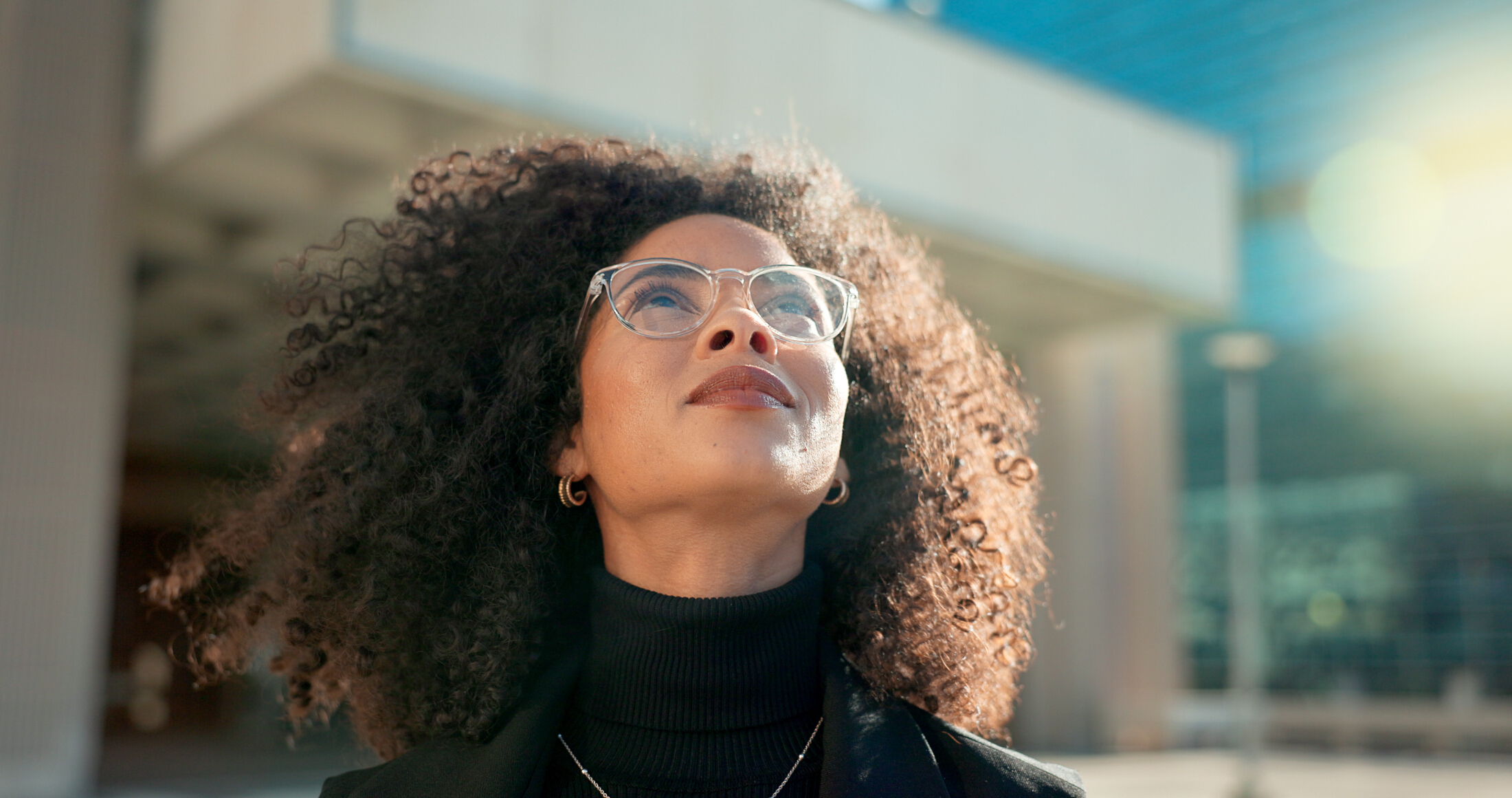 Curly Haired Woman Walking Outside In Sunlight City Background Adobe Stock 660860723