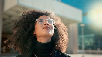 Curly Haired Woman Walking Outside In Sunlight City Background Adobe Stock 660860723