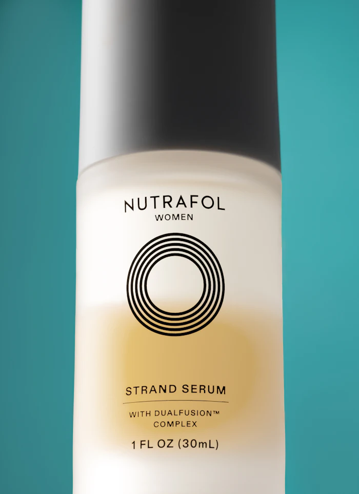 Nutrafol Women Strand Serum bottle with DualFusion Complex, 30mL, displayed against teal background
