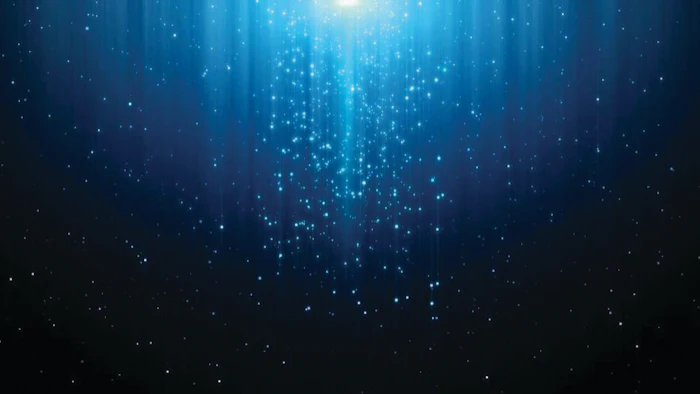 Abstract blue digital background with cascading light particles and rays emanating from center