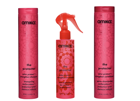 Amika The Protector hair care products in pink bottles including shampoo and protective spray