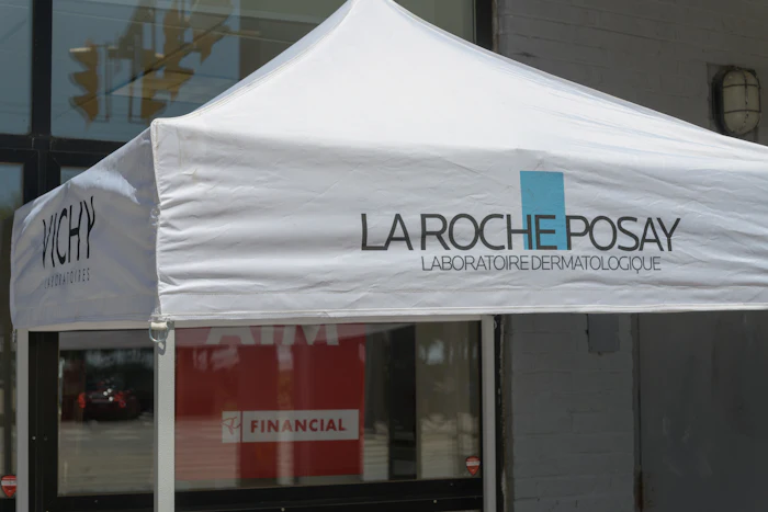 La Roche-Posay branded white tent canopy at retail storefront with dermatological laboratory signage