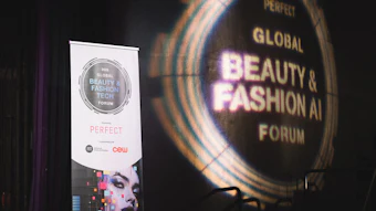 Global Beauty & Fashion AI Forum event signage with illuminated circular display and promotional banner at venue