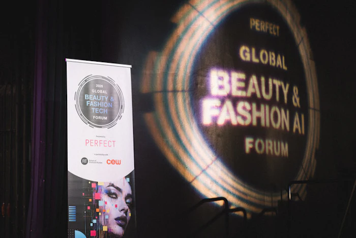 Global Beauty & Fashion AI Forum event signage with illuminated circular display and promotional banner at venue